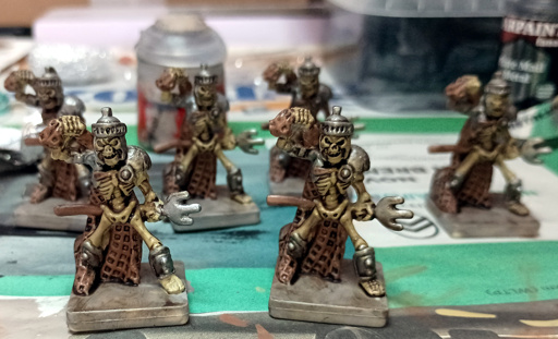 Five skeleton miniatures with a simple paint job